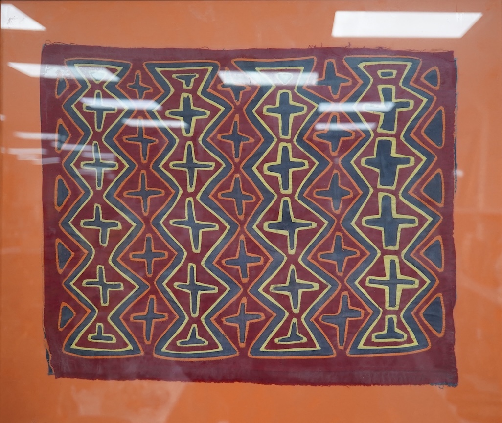 A framed Mola (Cuna Panama) appliqué worked shirt panel, mid 20th century, 45cm x 37cm. Condition - good